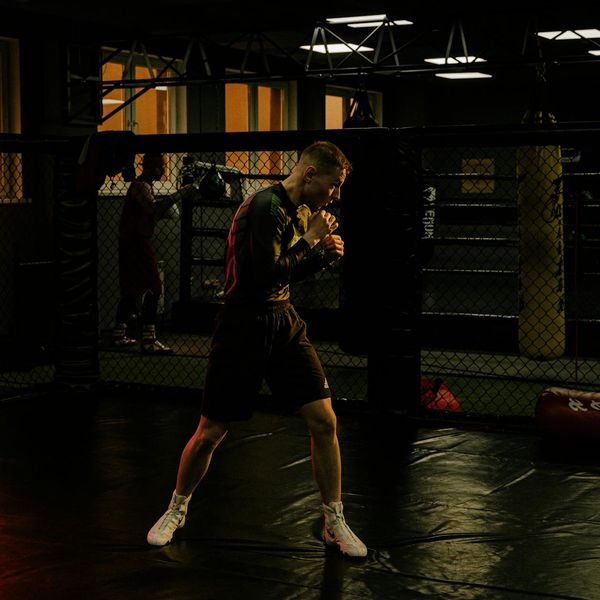 A focused man meditating after a workout session.